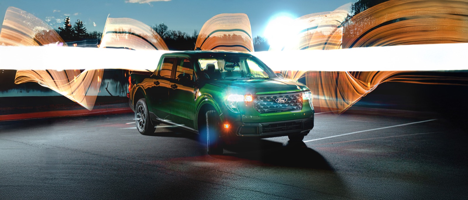 Pickup truck at night surrounded by light-painting streaks