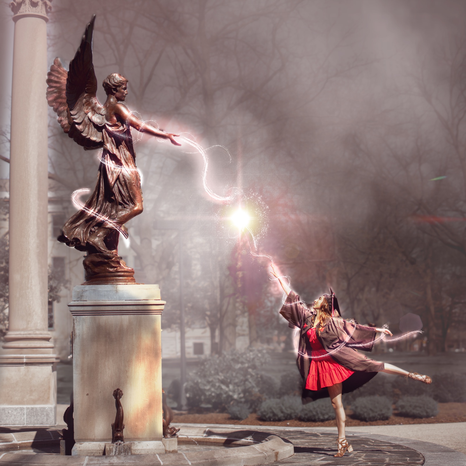 Dancer and bronze angel statue joined by lightning