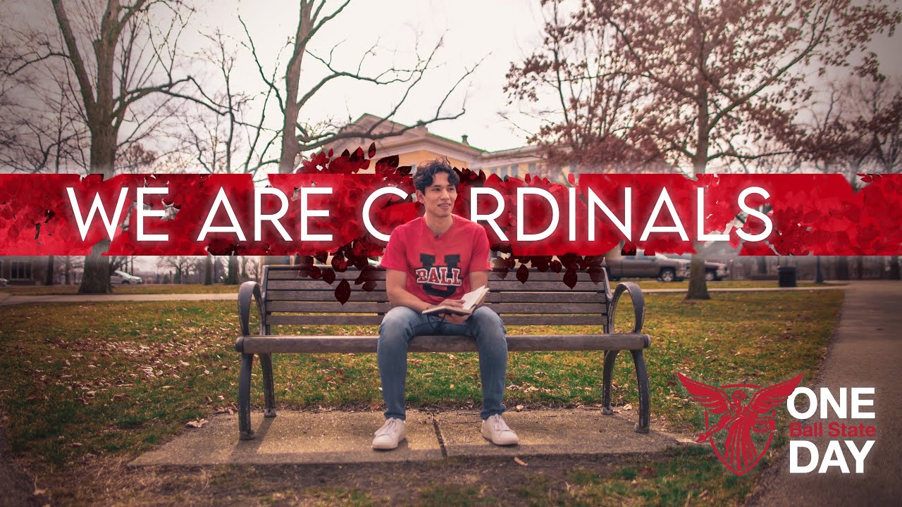 Edgar de Santiago on a campus bench under a red We Are Cardinals title