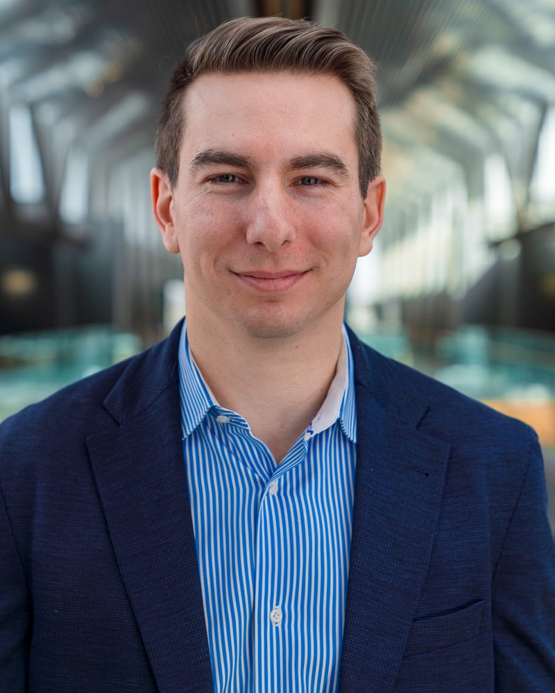 Employee headshot against the atrium, taken by Isaac