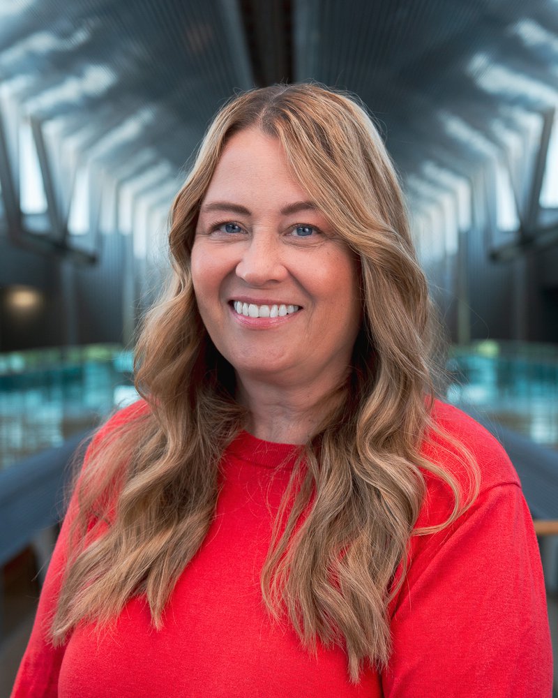 Employee headshot against the atrium, taken by Isaac
