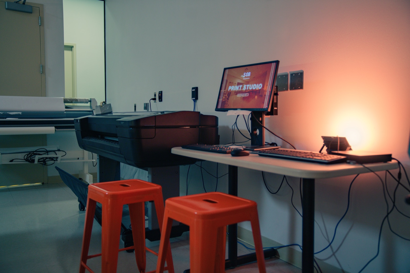 Large-format printer and orange stools