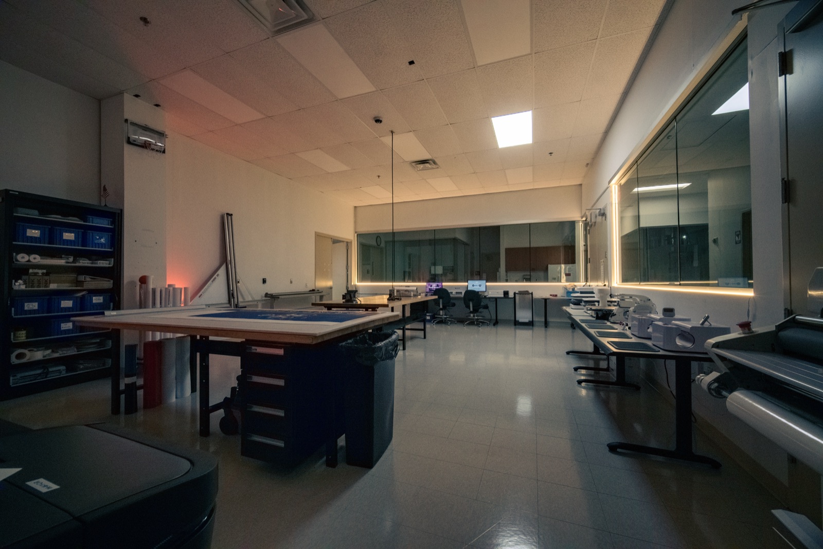 Print studio with a cutting table and vinyl rolls