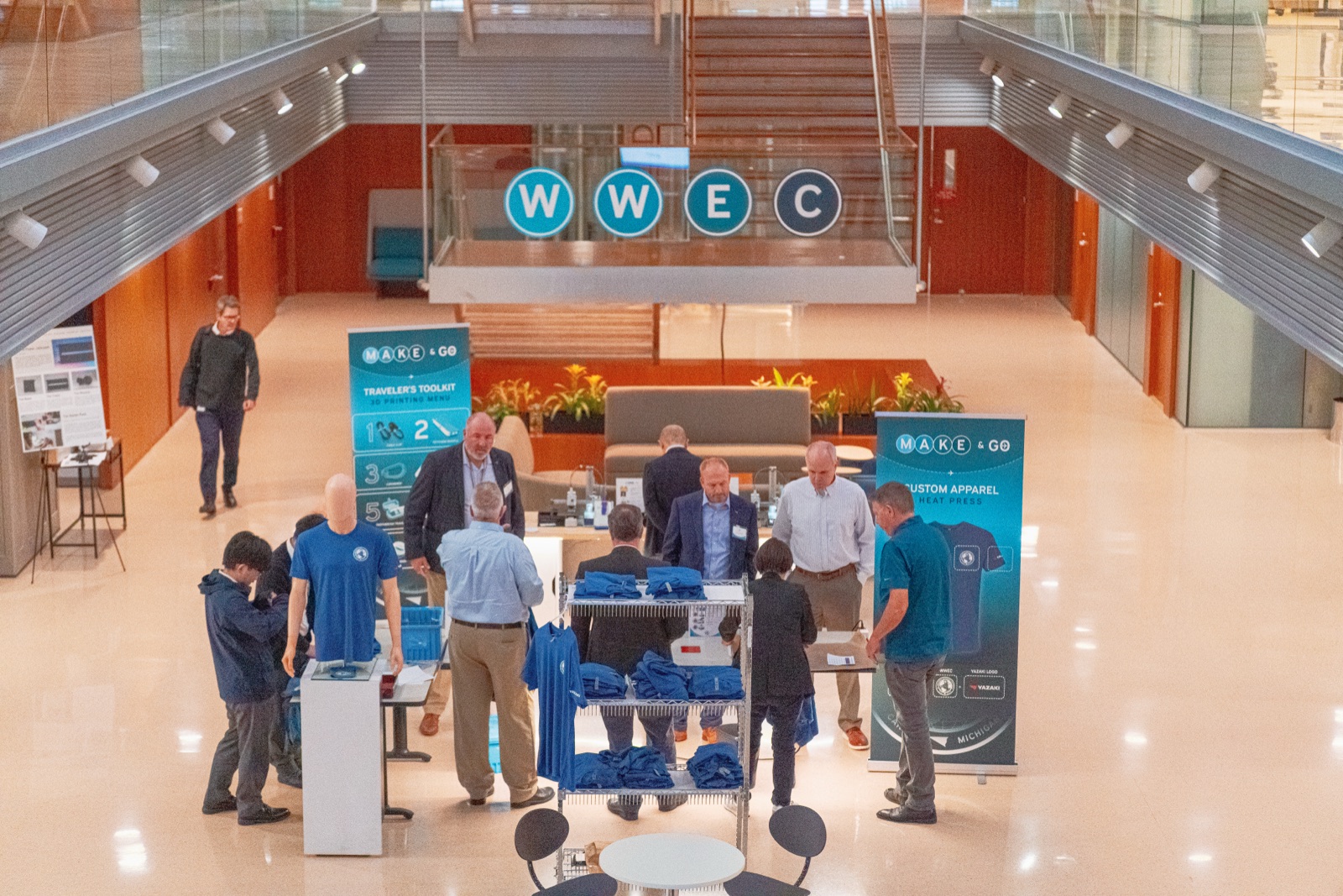 Crowd around Makerspace tables in the Worldwide Engineering Conference atrium