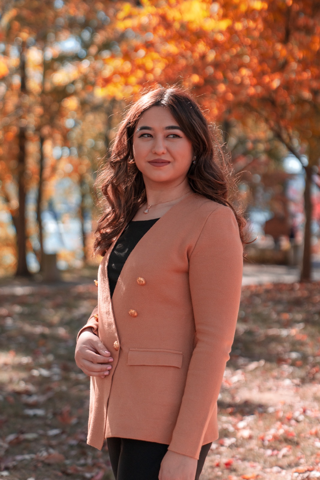 Woman in a blazer among autumn trees